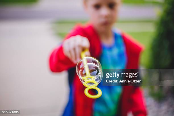 boy showing off his bubbles - annie otzen stock pictures, royalty-free photos & images