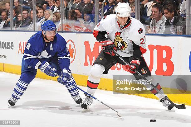 Francois Beauchemin of the Toronto Maple Leafs battles for the puck with Alexei Kovalev of the Ottawa Senators during game action October 6, 2009 at...