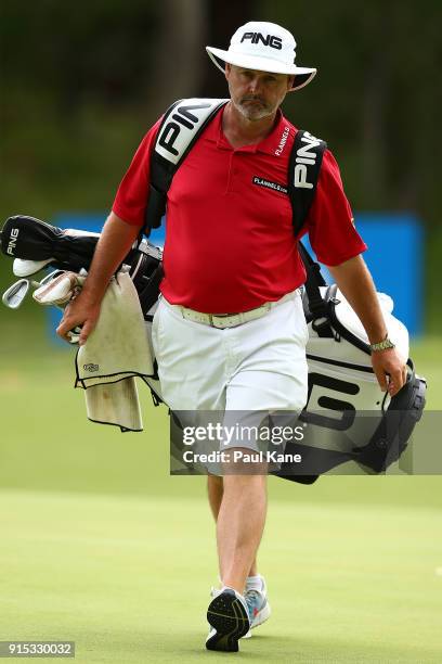 Billy Foster, caddie of Lee Westwood of England walks from the 2nd green during the pro-am ahead of the World Super 6 at Lake Karrinyup Country Club...