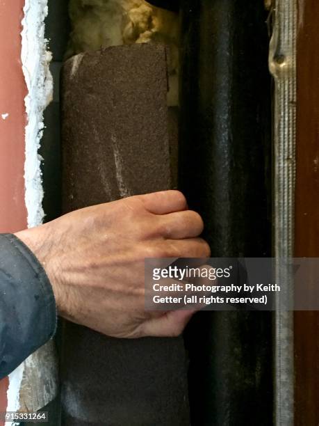 insulating a new drain pipe after a break from a winter freeze - frozen pipes stock pictures, royalty-free photos & images