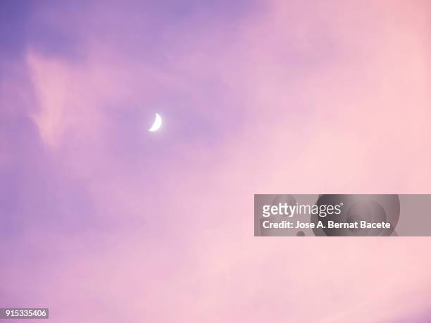 full frame of the low angle view of clouds of pink and fuchsia colors in sky during sunset with the waxing moon in the sky. valencian community, spain - sky full frame stock pictures, royalty-free photos & images