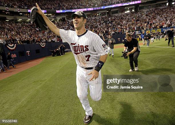 Joe Mauer of the Minnesota Twins circles the field after the Twins defeated the Detroit Tigers to win the American League Tiebreaker game on October...