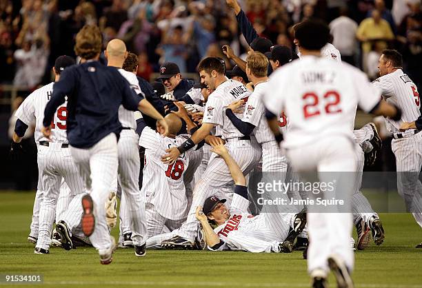 Joe Mauer and the Minnesota Twins celebrate after defeating the Detroit Tigers during the American League Tiebreaker game on October 6, 2009 at...