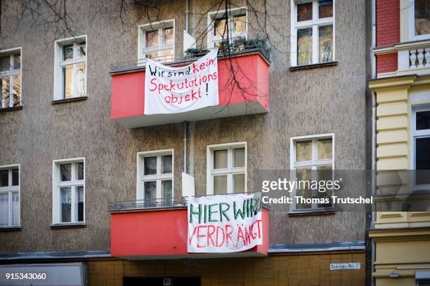 Berlin, Germany On the balconies of a residential building in Berlin Neukoelln hang banners with the inscription 'here is displaced' and 'We are not...