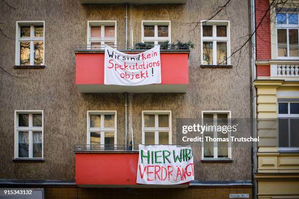 Berlin, Germany On the balconies of a residential building in Berlin Neukoelln hang banners with the inscription 'here is displaced' and 'We are not...