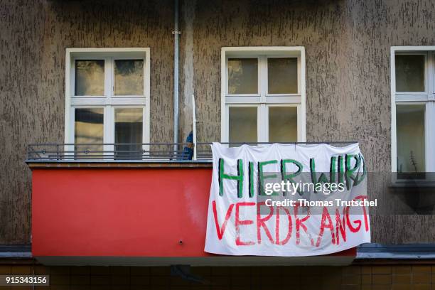 Berlin, Germany On a balcony a residential building in Berlin Neukoelln hanging banner with the inscription ' here is displaced ' on February 07,...