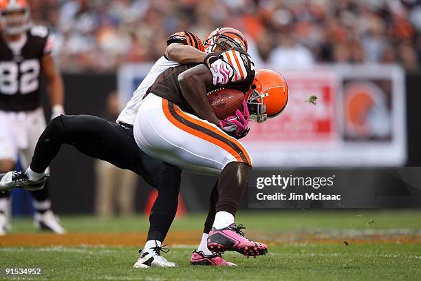 Mohamed Massaquoi of the Cleveland Browns is tackled by Leon Hall of the Cincinnati Bengals during their game at Cleveland Browns Stadium on October...