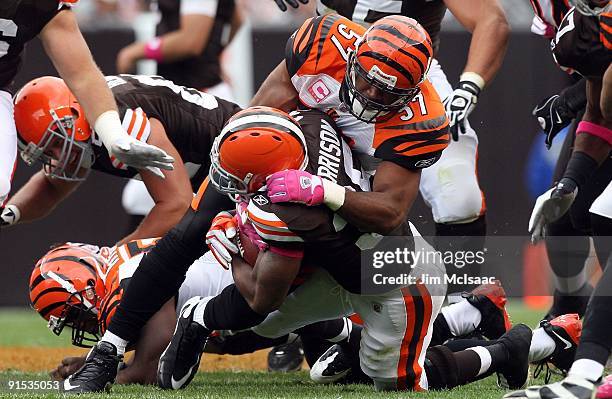 Dhani Jones of the Cincinnati Bengals makes a tackle against the Cleveland Browns during their game at Cleveland Browns Stadium on October 4, 2009 in...