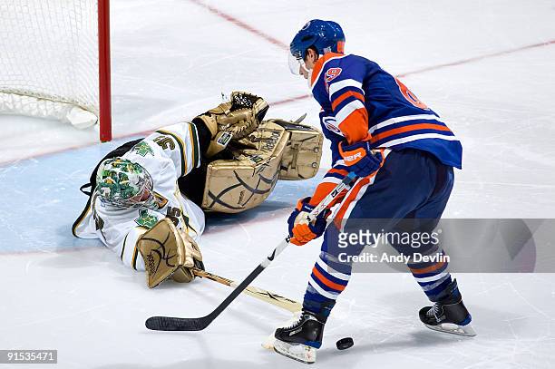 Marty Turco of the Dallas Stars pokechecks Sam Gagner of the Edmonton Oilers during the shoot-out on October 6, 2009 at Rexall Place in Edmonton,...