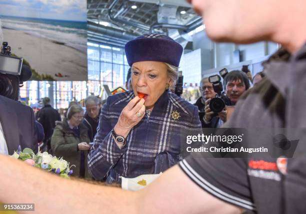 Princess Benedikte of Denmark tastes a sausage during the walkabout of the danish part of HAMBURG REISEN at Hamburg Messe on February 7, 2018 in...