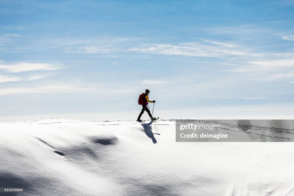 Woman snowshoeingon snow field
