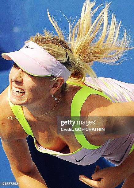 Maria Sharapova of Russia follows through on a serve against Victoria Azarenka of Belarus during their second round match at the China Open 2009 in...