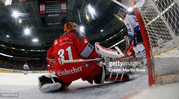 Levente Szuper , goalkeeper of Hannover saves the shot of Colin Forbes of Mannheim during the DEL match between Hannover Scorpions and Adler Mannheim...