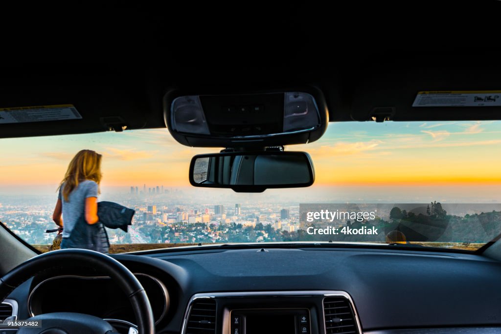 People taking photo of Los Angeles after sunset from Hollywood Bowl.