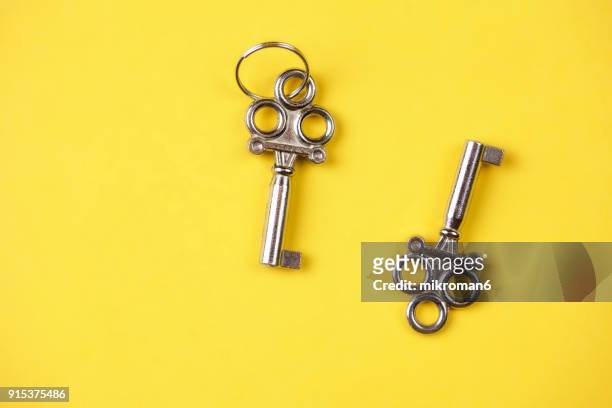 close-up of keys on yellow background - suitcase close stock-fotos und bilder