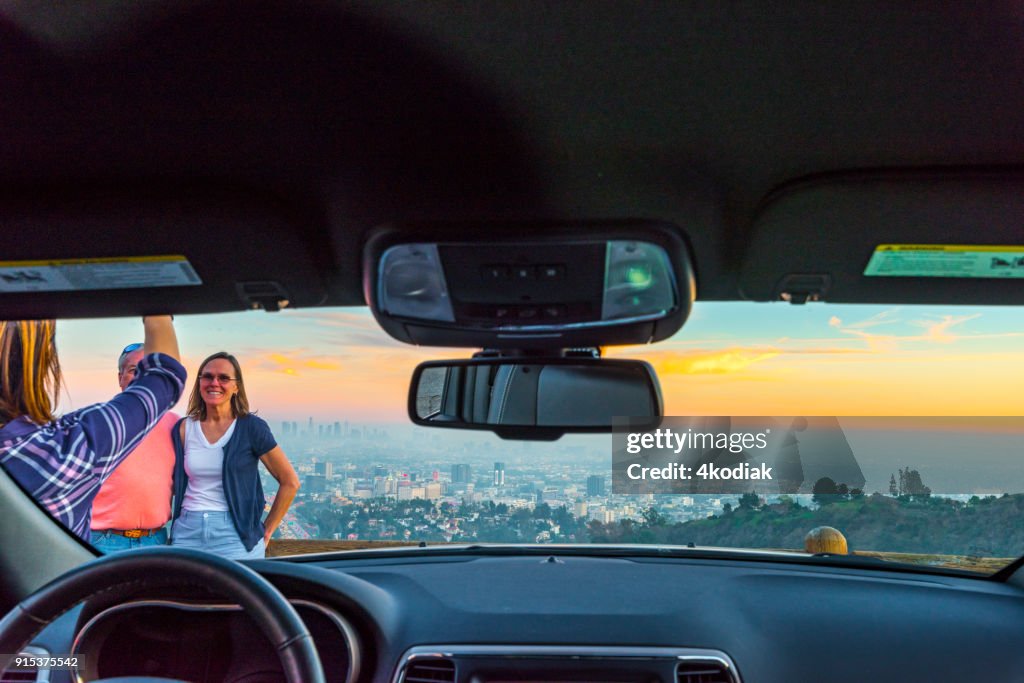 People taking photo of Los Angeles after sunset from Hollywood Bowl.
