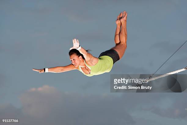 trapeze is a popular new exercise in the states - trapeze artist stock pictures, royalty-free photos & images