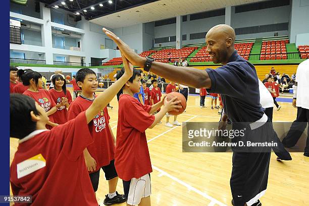 Bruce Bowen high fives a child during an NBA Cares event on October 7, 2009 at Taipei Gymnasium in Taipei, Taiwan. NOTE TO USER: User expressly...