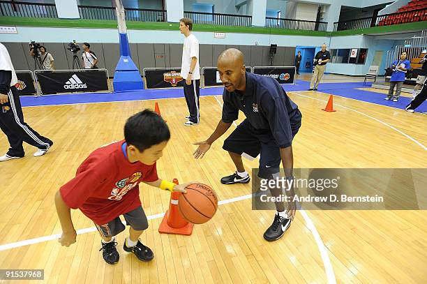 Bruce Bowen demonstrates defense with a child during an NBA Cares event at on October 7, 2009 at Taipei Gymnasium in Taipei, Taiwan. NOTE TO USER:...
