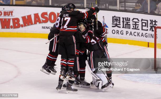 Cayden Primeau of the Northeastern Huskies is surrounded by teammates Eric Williams, Matt Filipe, Zach Solow and Adam Gaudette after a 3-0 victory...
