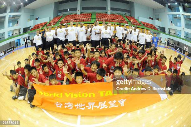 The Indiana Pacers pose with children during an NBA Cares event on October 7, 2009 at Taipei Gymnasium in Taipei, Taiwan. NOTE TO USER: User...