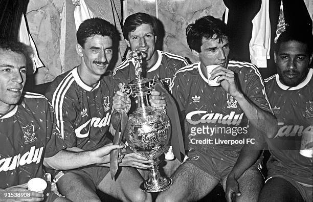 Liverpool players Ronnie Rosenthal, Ian Rush, Ronnie Whelan, captain Alan Hansen and John Barnes celebrate winning the league title with the trophy...