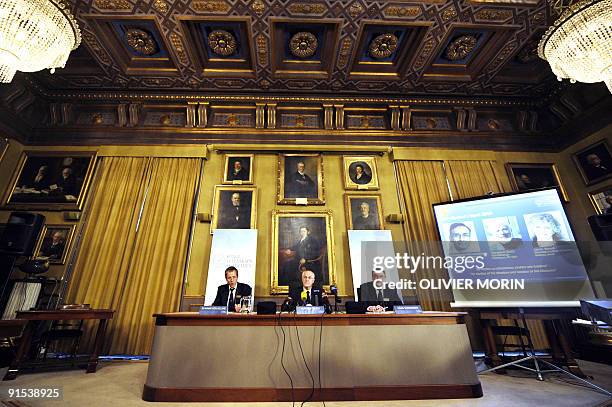 Photos of Venkatraman Ramakrishnan and Thomas Steitz of the US and Israel's Ada Yonath are displayed on a screen as they win the Nobel Chemistry...