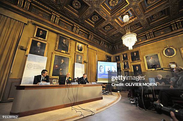 Photos of Venkatraman Ramakrishnan and Thomas Steitz of the US and Israel's Ada Yonath are displayed on a screen as they win the Nobel Chemistry...