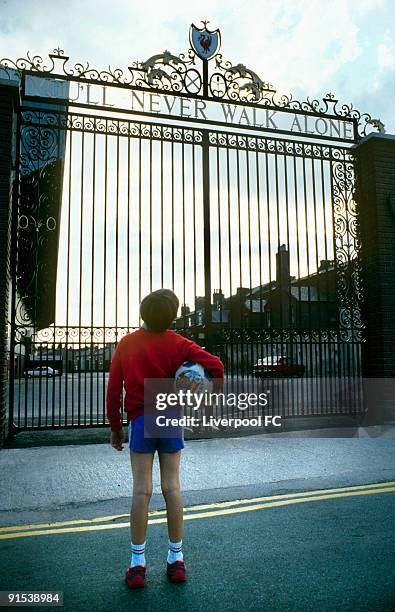 Young footballer looks up at the Shankly Gates and dreams of pulling on the red shirt for his club.