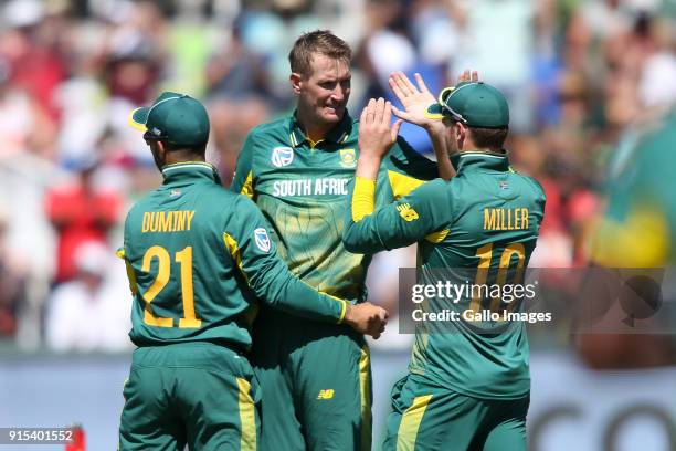 Duminy of South Africa and David Miller of South Africa congratulate Chris Morris of South Africa for getting Hardik Pandya of India wicket during...