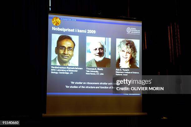 Photos of Venkatraman Ramakrishnan and Thomas Steitz of the US and Israel's Ada Yonath are displayed on a screen as they win the Nobel Chemistry...