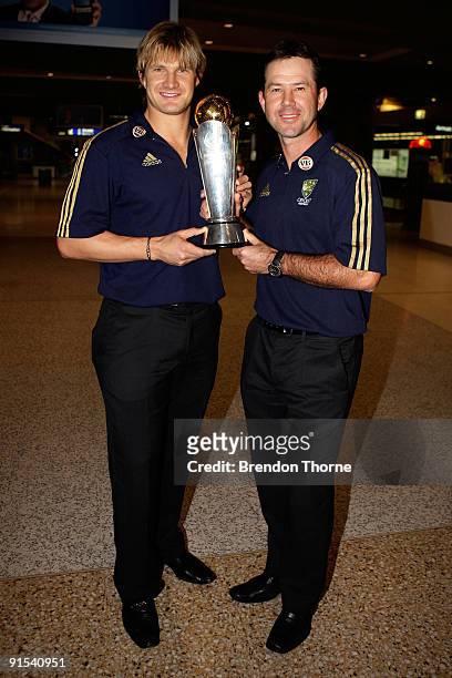 Ricky Ponting and Shane Watson of Australia pose for a photograph with the ICC trophy during a press conference upon their return to Australia at...