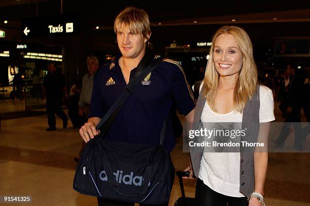 Shane Watson and his partner Lee Furlong walk through the airport terminal during a press conference upon their return to Australia at Sydney...