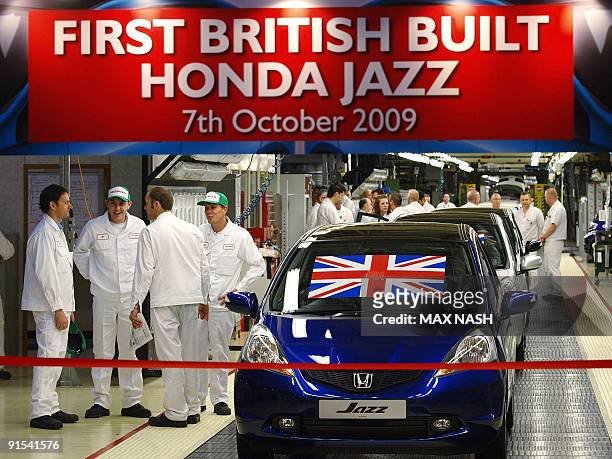 Workers wait for the launch of the first British built Honda Jazz family supermini to leave the production line at the Honda car plant in Swindon,...