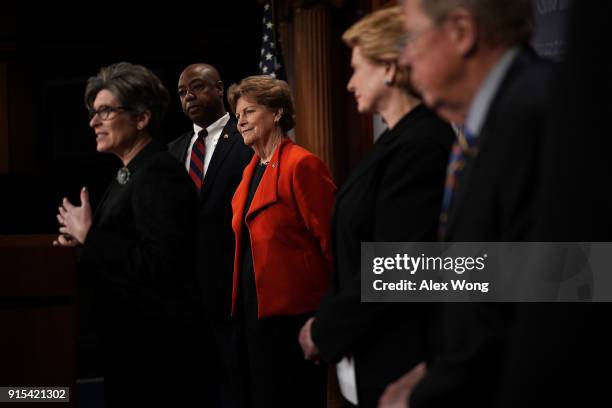 Sen. Joni Ernst speaks as Sen. Tim Scott , Sen. Jeanne Shaheen , Sen. Debbie Stabenow and Sen. Johnny Isakson listen during a news conference at the...