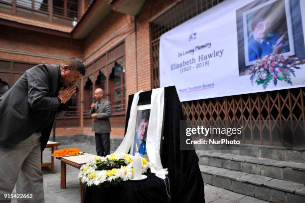 Former president of the Nepal Mountaineering Association Ang Tshering Sherpa offering flower towards poster of Legendary Elizabeth Hawley during the...