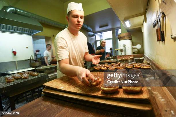 Staff of Krakow's well-known bakery 'Cichowscy' produces donuts for Fat Thursday. Fat Thursday is a traditional Catholic Christian feast on the last...