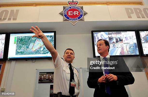 David Cameron is shown around the Police Command Centre as he tours the centre with his wife Samantha on the third day of the Conservative Party...