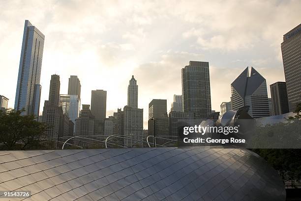 The downtown skyline begins to glow as the sun sets over the Jay Pritzker Pavilion and the Columbus Drive walkway as seen in this 2009 Chicago,...