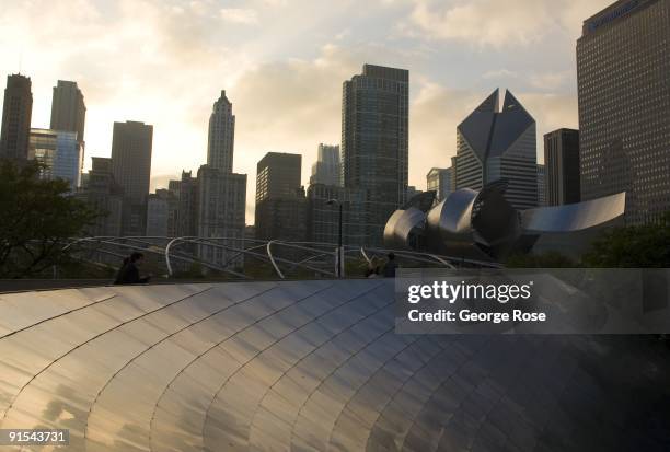 The downtown skyline begins to glow as the sun sets over the Jay Pritzker Pavilion and the Columbus Drive walkway as seen in this 2009 Chicago,...