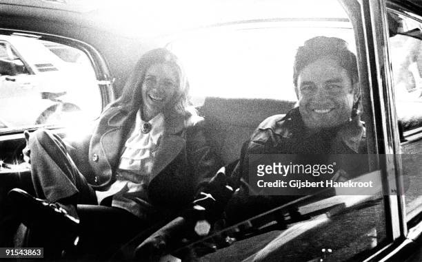 Johnny Cash and June Carter posed together in the back seat of their limousine in Amsterdam, Holland in 1972