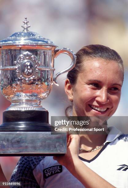 Iva Majoli of Croatia poses with the trophy after defeating Martina Hingis of Switzerland in the Women's Singles Final of the French Open Tennis...