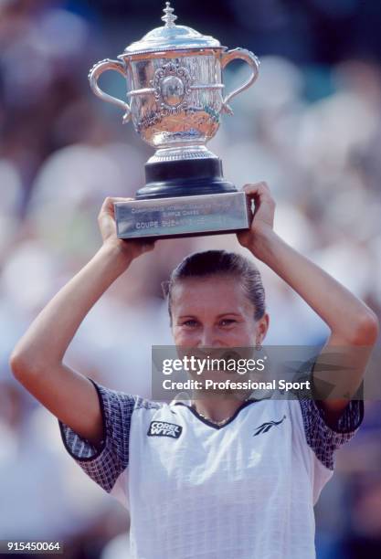 Iva Majoli of Croatia lifts the trophy after defeating Martina Hingis of Switzerland in the Women's Singles Final of the French Open Tennis...