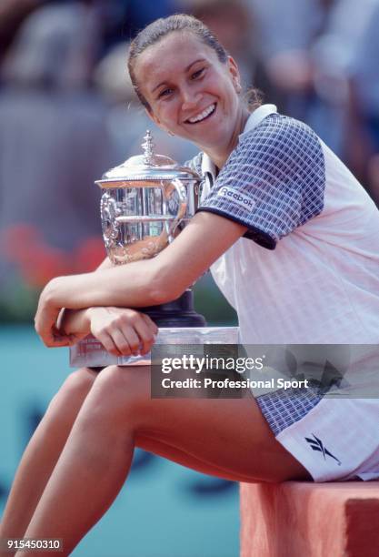 Iva Majoli of Croatia poses with the trophy after defeating Martina Hingis of Switzerland in the Women's Singles Final of the French Open Tennis...