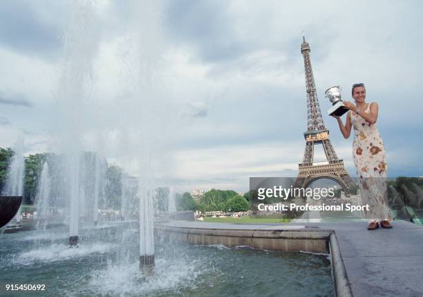 Iva Majoli of Croatia poses with the trophy in front of the Eiffel Tower after defeating Martina Hingis of Switzerland in the Women's Singles Final...