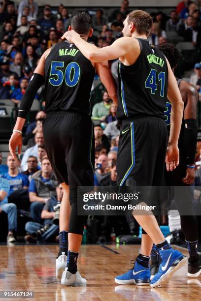 Dirk Nowitzki puts his arm around Salah Mejri of the Dallas Mavericks during the game against the Miami Heat on January 29, 2018 at the American...