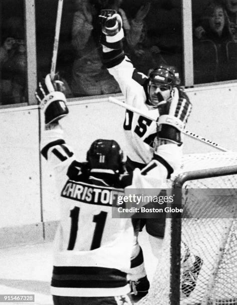 Hockey players Steve Christoff, left, and Mike Eruzione, right, react after scoring a goal against an Olympics game against Norway in Lake Placid,...