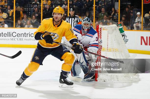 Scott Hartnell of the Nashville Predators battles in front of goalie Henrik Lundqvist of the New York Rangers during an NHL game at Bridgestone Arena...