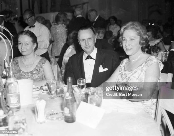 Dutch-born Swiss Baron Hans Heinrich von Thyssen-Bornemisza sits between American theater producer Jean Dalrymple and socialite Fay Lavan at the Red...