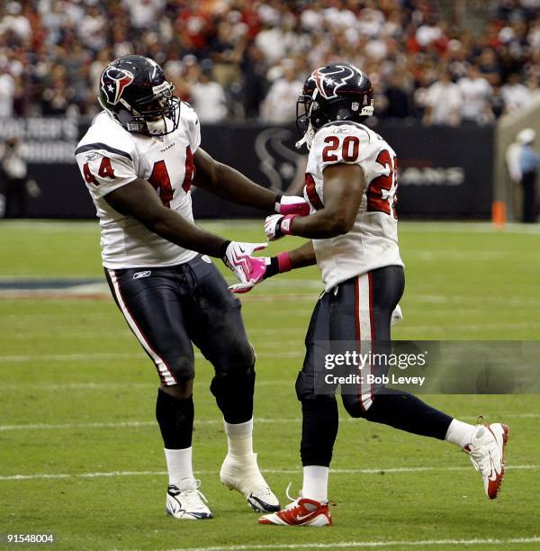 Running back Steve Slaton of the Houston Texans celebrates with Vonta Leach after his score at Reliant Stadium on October 4, 2009 in Houston, Texas.